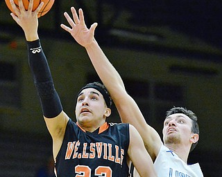 Jeff Lange | The Vindicator  TUE, MAR 1, 2016 - Wellsville's Mike Shope (23) looks to the basket for a layup in front of the defensive efforts of Lisbon's Trevor Reese during Tuesday night's DIV district semifinal game in Struthers.