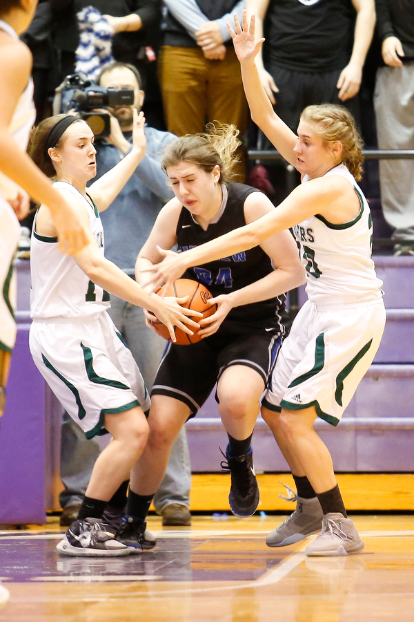 Elyria Catholic's Riley Schill (12) and Sam Filiaggi (20) guard Lakeview's Assie Becker (34) during their  Division II girls regional semifinal game at Barberton High School, Tuesday, March 1, 2016, in Barberton, Ohio. Elyria Catholic beat Lakeview 50-44. Alex Slitz for The Vindicator