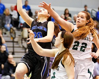 Lakeview's Lindsay Carnahan (20) goes to the hoop against Elyria Catholic's Nora Hopkins (22) And Riley Schill (12) during their  Division II girls regional semifinal game at Barberton High School, Tuesday, March 1, 2016, in Barberton, Ohio. Elyria Catholic beat Lakeview 50-44. Alex Slitz for The Vindicator