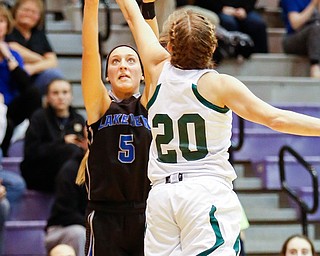 Lakeview's Jensen Silbaugh (5) shoots over Elyria Catholic's Sam Filiaggi (20) during their  Division II girls regional semifinal game at Barberton High School, Tuesday, March 1, 2016, in Barberton, Ohio. Elyria Catholic beat Lakeview 50-44. Alex Slitz for The Vindicator