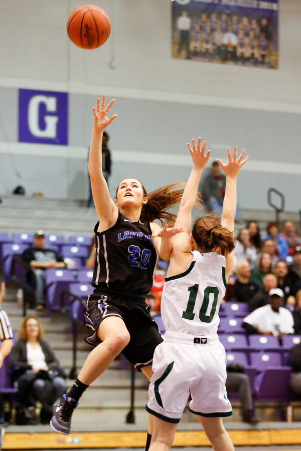 Lakeview's Lindsay Carnahan (20) shoot past Elyria Catholic's Regan Schill (10) during their  Division II girls regional semifinal game at Barberton High School, Tuesday, March 1, 2016, in Barberton, Ohio. Elyria Catholic beat Lakeview 50-44. Alex Slitz for The Vindicator