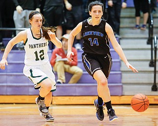 Lakeview's Cammie Becker (14) drives past Elyria Catholic's Riley Schill (12) during their  Division II girls regional semifinal game at Barberton High School, Tuesday, March 1, 2016, in Barberton, Ohio. Elyria Catholic beat Lakeview 50-44. Alex Slitz for The Vindicator