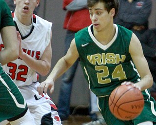 William d lewis the vindicator  Ursuline Greg Pzrella(24) drives around Canfield's Julian Vitto(32).
