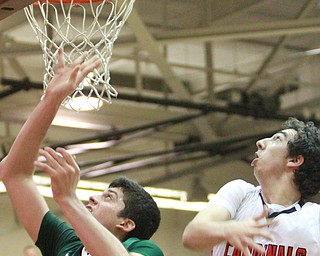 William d Lewis The Vindicator  Ursuline's Armon Nasseri(33) puts up a shot past canfield'sSam digiacomo (42).
