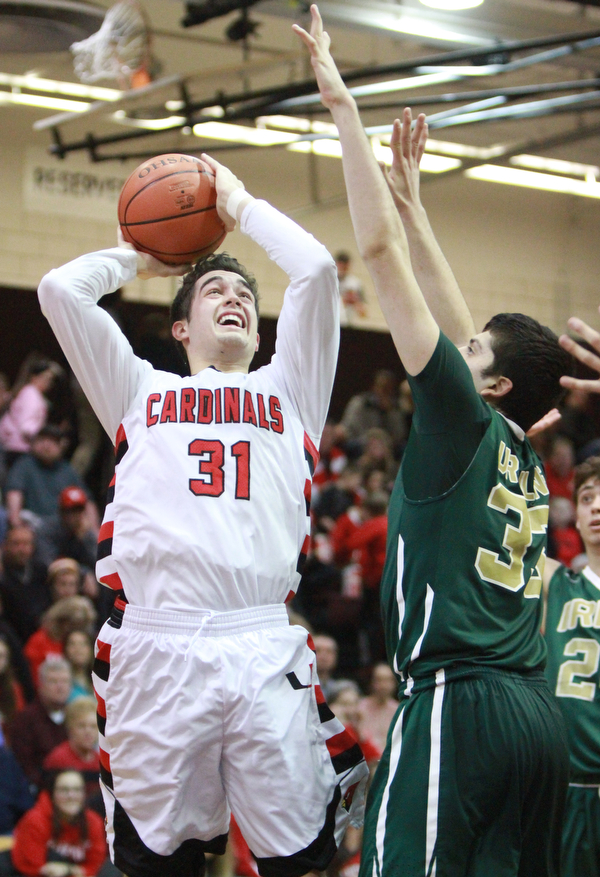 William d Lewis The Vindicator Canfield'sVince Ferrier(31) shoots past Ursuline's Armon Nasseri(33)
