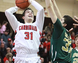William d Lewis The Vindicator Canfield'sVince Ferrier(31) shoots past Ursuline's Armon Nasseri(33)