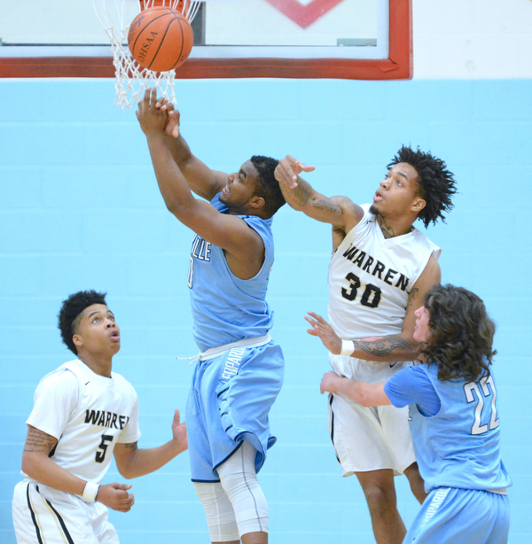Jeff Lange | The Vindicator  WED, MAR 2, 2016 - Warren Harding's Kahmaree Bush (5) and Lynn Bowden (30) knock the ball out of the hands of Louisville's Rahul Young (center) as Jared Holland (22) looks on during first half action of their DI district semifinal in Alliance on Wednesday.