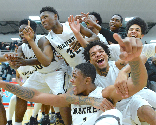 Jeff Lange | The Vindicator  WED, MAR 2, 2016 - Derek Culver (bottom left) and Lynn Bowden (bottom right) celebrate with teammates after Harding defeated Louisville 62-58 to advance to the district championship Wednesday night at Alliance High School.