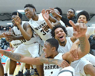 Jeff Lange | The Vindicator  WED, MAR 2, 2016 - Derek Culver (bottom left) and Lynn Bowden (bottom right) celebrate with teammates after Harding defeated Louisville 62-58 to advance to the district championship Wednesday night at Alliance High School.