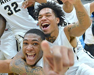 Jeff Lange | The Vindicator  WED, MAR 2, 2016 - Warren G. Harding's Derek Culver (bottom) and Lynn Bowden celebrate after their 62-58 victory over Louisville in the DI district semifinal at Alliance High School.