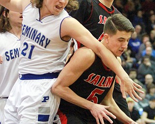 William D Lewis the Vindicator Salem's Jon Gerace(5) keeps the ball from Poland's Jake Buccieri(21) during 3-3-16 action at Boardman. In backsround is Salem's Nick Rusyn(44).