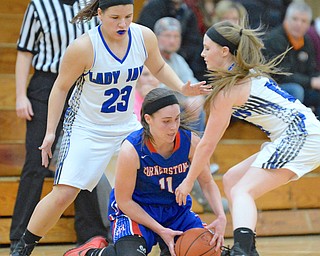 Jeff Lange | The Vindicator  THU, MAR 3, 2016 - Jackson-Milton's Katie Rago (23) and Kaitlyn Totani (right) work to steal the ball away from Cornerstone's Jordan Cloonan in the second half of Thursday night's game in Massillon.