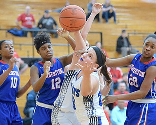 Jeff Lange | The Vindicator  THU, MAR 3, 2016 - Amid a host of Cornerstone players, Jackson-Milton's Katie Rago (center) looks to snag a rebound in the second half of their DIV regional semifinal at Massillon Perry High School Thursday night. Cornerstone players pictured, from left, Ashley West, Mickayla Baldwin and Lauren Harris.