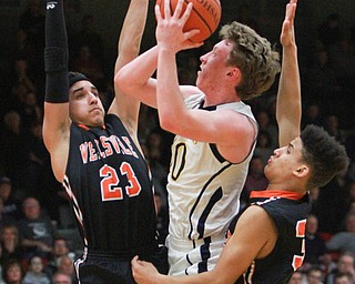 William d Lewis the Vindicator  McDonald's Evan Magill(10) shoots between Wellsville's MikeShope(23) and  Brandon bennett(30) after McDonald defeated wellsvile 3-4-16 at Struthers.