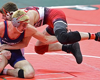 COLUMBUS, OHIO - MARCH 4, 2016: Adam Green of Fitch grabs the leg of Dylan Roth of Cincinnati Oak Hills as he flies through the air in transition during their 160lb Division I championship bracket bout Friday afternoon at Schottenstein Center. DAVID DERMER | THE VINDICATOR