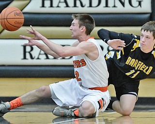 Jeff Lange | The Vindicator  FRI, MAR 4, 2016 - Newton Falls' Noah Suarez (2) makes a pass from the floor in front of Garrettsville Garfield's Devin Karlovec (11) in the second half of their DIII district championship game at Harding High School Friday night.