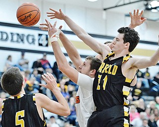 Jeff Lange | The Vindicator  FRI, MAR 4, 2016 - Newton Falls' Ben Simpson (center) has his shot slapped away by Garrettsville Garfield's Seth Morgan (right) as Tommy Bissler looks on during first half action of their game Friday night in Warren.