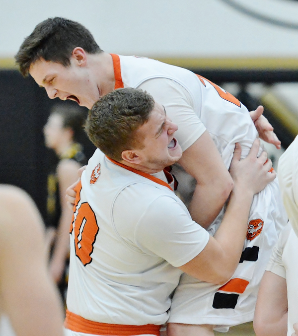 Jeff Lange | The Vindicator  FRI, MAR 4, 2016 - In celebration of their 34-31 win over Garrettsville Garfield, Newton Falls' Ben Koonts (bottom) lifts teammate Alan Boone over his shoulder Friday night in Warren.