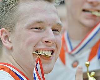 Jeff Lange | The Vindicator  FRI, MAR 4, 2016 - Newton Falls senior Alex Ball smiles as he bites his medal after defeating Garrettsville Garfield 34-31 in the DIII district championship Friday night in Warren.