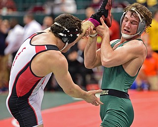COLUMBUS, OHIO - MARCH 5, 2016: John Szep of Mentor Lake Catholic picks up the leg of Dominic Cooper of Canfield before attempting to kick out his leg during their 182lb Division II consolation bracket bout Saturday morning at Schottenstein Center. DAVID DERMER | THE VINDICATOR