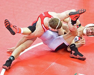COLUMBUS, OHIO - MARCH 5, 2016: Tyler Copeland of Wapakoneta controls the legs of C.J. Frost of Canfield while working his shoulders to the mat during their 138lb Divison II third place bout Saturday morning at Schottenstein Center. DAVID DERMER | THE VINDICATOR