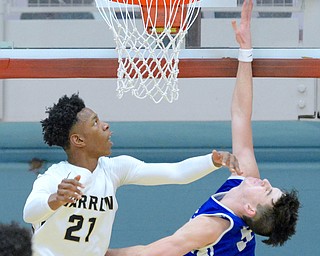 Jeff Lange | The Vindicator  SAT, MAR 5, 2016 - Warren Harding's Shakem Johnson (21) smacks Lake's Chandler Vaudrin as he attempts a layup in the second half of their Division I district championship game at Alliance High School Saturday night.