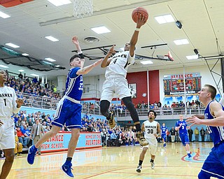 Jeff Lange | The Vindicator  SAT, MAR 5, 2016 - Harding's Gabe Simpson (4) soars to the basket past Lake's Drew Myers (33) as a host of Lake and Harding players look on in the final 28 seconds of their Division I district championship game in Alliance Saturday night. Harding won 48-42.