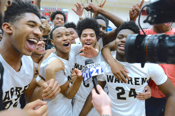 Jeff Lange | The Vindicator  SAT, MAR 5, 2016 - Warren Harding players mob around a television camera during Gabe Simpson's post-game interview with WKBN Saturday night at Alliance High School. The Raiders won 48-42 and will play Garfield Heights in the regional semifinal at the Wolstein Center in Cleveland on Wednesday.