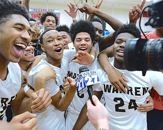 Jeff Lange | The Vindicator  SAT, MAR 5, 2016 - Warren Harding players mob around a television camera during Gabe Simpson's post-game interview with WKBN Saturday night at Alliance High School. The Raiders won 48-42 and will play Garfield Heights in the regional semifinal at the Wolstein Center in Cleveland on Wednesday.