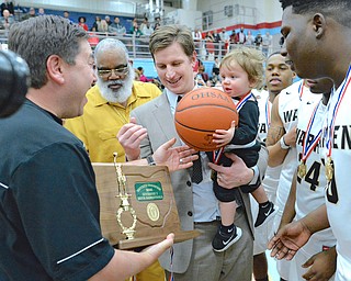 Jeff Lange | The Vindicator  SAT, MAR 5, 2016 - Raiders head coach Andy Vlajkovich (center) smiles as the game ball is presented to his 16 month old son Milan after Harding won the Division district championship against Lake at Alliance High School on Saturday.