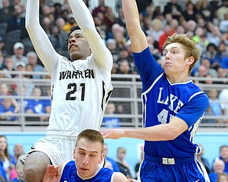 Jeff Lange | The Vindicator  SAT, MAR 5, 2016 - Harding's Shakem Johnson (top left) looks to the basket past Lake's Jack Lostoski (bottom) and Matt Jones in the first half of Saturday's Division I district championship in Alliance.