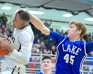 Jeff Lange | The Vindicator  SAT, MAR 5, 2016 - Warren Harding's Derek Culver is slapped in the face by Lake's Matt Jones (45) after rebounding the ball late in the second half of Saturday's Division I district championship in Alliance.