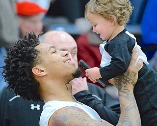 Jeff Lange | The Vindicator  SAT, MAR 5, 2016 - Harding junior Lynn Bowden shares a moment of joy with coach Andy Vlajkovich's 16 month old son Milan after defeating Lake 48-42 in the Division I district championship in Alliance on Saturday.