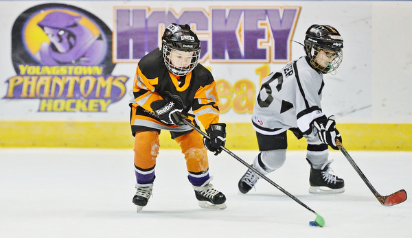Jeff Lange | The Vindicator  SUN, MAR 6, 2016 - Youngstown's Breen Dahman (age 7 left) handles the puck as Dayton Stealth's Elliott Baker trails from behind in the second half of their consolation game during the Phantoms ADM Fantastic Finale 4-8 year old Tournament held at the Covelli Centre and Ice Zone in Boardman on Sunday.
