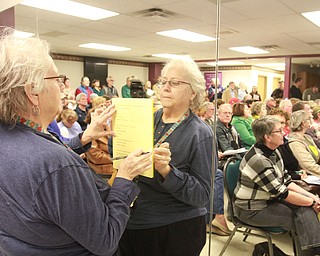 William d Lewis The vindicator Jean cole of Warren fills out an information form during  public meeting Monday 3-7-16 concerning recent Mill Creek PArk happenings. About 200 people attended the event.