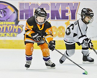 Jeff Lange | The Vindicator  SUN, MAR 6, 2016 - Youngstown's Breen Dahman (age 7 left) handles the puck as Dayton Stealth's Elliott Baker trails from behind in the second half of their consolation game during the Phantoms ADM Fantastic Finale 4-8 year old Tournament held at the Covelli Centre and Ice Zone in Boardman on Sunday.