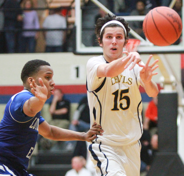 William D Lewis The Vindicator McDonalds JAke Reckard(15) passes around Lutheran East's Derrick Veasley(1) during 3-8-16 action in Canton.