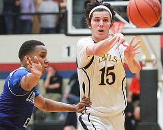 William D Lewis The Vindicator McDonalds JAke Reckard(15) passes around Lutheran East's Derrick Veasley(1) during 3-8-16 action in Canton.