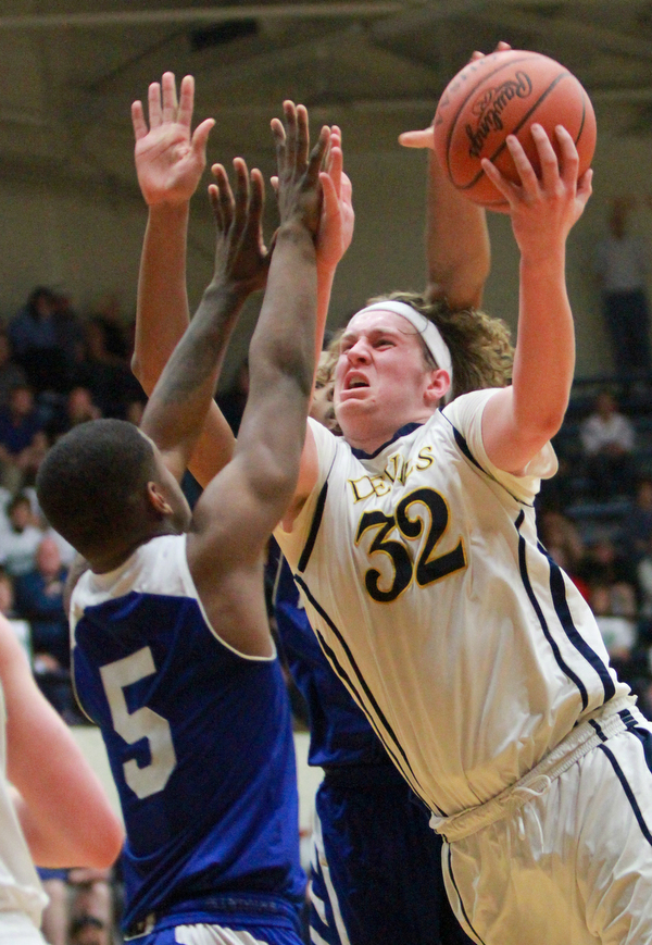 William D. Lewis The Vindicator  McDonald's Matt howard(32) tries to shoot past Luteran east'sKaylinHeard(5) during McDonald's loss to Lutheran East in Canton 3-8-16.