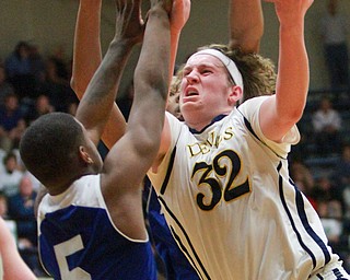 William D. Lewis The Vindicator  McDonald's Matt howard(32) tries to shoot past Luteran east'sKaylinHeard(5) during McDonald's loss to Lutheran East in Canton 3-8-16.