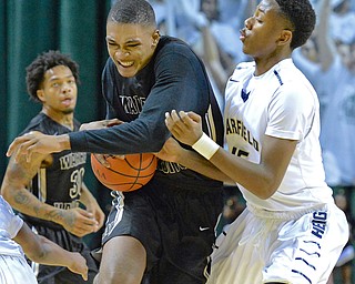Jeff Lange | The Vindicator  WED, MAR 9, 2016 - Warren Harding's Derek Culver (left) drives to the basket around the defensive efforts of Garfield Heights' Braun Hartfield in the first half of their Division I regional semifinal held at the Wolstein Center in Cleveland on Wednesday. Harding fell the Bulldogs 49-43.