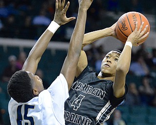Jeff Lange | The Vindicator  WED, MAR 9, 2016 - Warren Harding senior Gabe Simpson (4) looks to the net for two past the defense of Garfield Height's Braun Hartfield Wednesday night at the Wolstein Center in Cleveland.