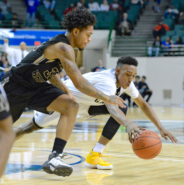 Jeff Lange | The Vindicator  WED, MAR 9, 2016 - Harding's Lynn Bowden (left) dives for the ball against Garfield Heights' Frankie Hughes in the third quarter of their Division I regional semifinal held at the Wolstein Center in Cleveland on Wednesday.