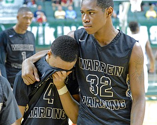 Jeff Lange | The Vindicator  WED, MAR 9, 2016 - Warren Harding's Javeonyae Artis (32) consoles teammate Gabe Simpson (4) after the Raiders' 49-43 loss to Garfield Heights in a Division I regional semifinal held at the Wolstein Center in Cleveland on Wednesday.