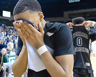 Jeff Lange | The Vindicator  WED, MAR 9, 2016 - Harding senior Gabe Simpson hides his face in his jersey after losing, 49-43, to Garfield Heights in a Division I regional semifinal held at the Wolstein Center on Wednesday.