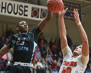 William d Lewis the Vindicator  N FallsBen simpson(50) shoots around VASJ Alan Boone(23) during 3-8-16 action in Canton.