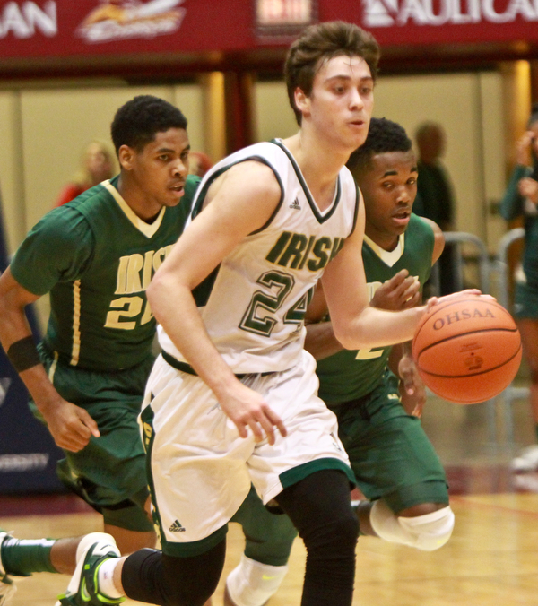 William D Lewis the Vindicator Ursuline's Greg Parella(24) moves the ball as SVSM'sHenry Baddley(2) and Malik Wooldridge(2) defend during 3-10-16 action at Canton.