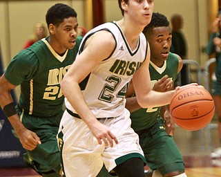 William D Lewis the Vindicator Ursuline's Greg Parella(24) moves the ball as SVSM'sHenry Baddley(2) and Malik Wooldridge(2) defend during 3-10-16 action at Canton.