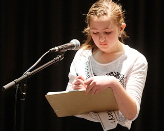      ROBERT K. YOSAY  | THE VINDICATOR..Mariah Milan Leskovac - spells a word by pen and ink- Mariah is main schooled and won her bee at Roosevelt Elementary McDonald... the pen and ink were to be sure of the spelling as she has a hearing impairment..THE VINDICATOR 83rd Regional Spelling Bee  at YSU Kilcawley Room...--30-...