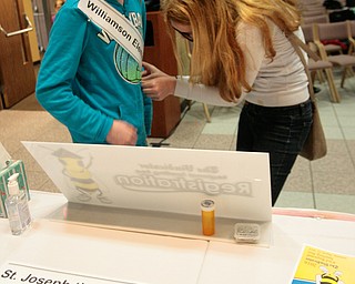      ROBERT K. YOSAY  | THE VINDICATOR..SASHA....   Williamson Elementary  Emily Thompson gets her sash in place with the help of her sister Hahhah Leszyeski ..THE VINDICATOR 83rd Regional Spelling Bee  at YSU Kilcawley Room...--30-...